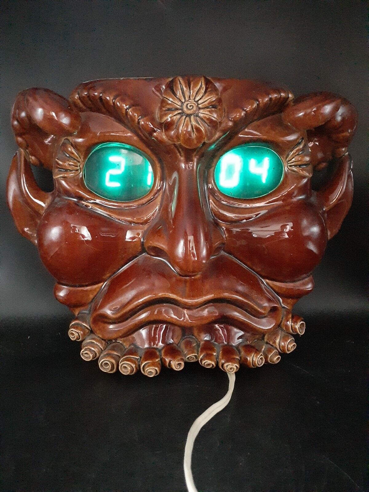 Vintage Soviet electronic wall clock in the form of a demon.