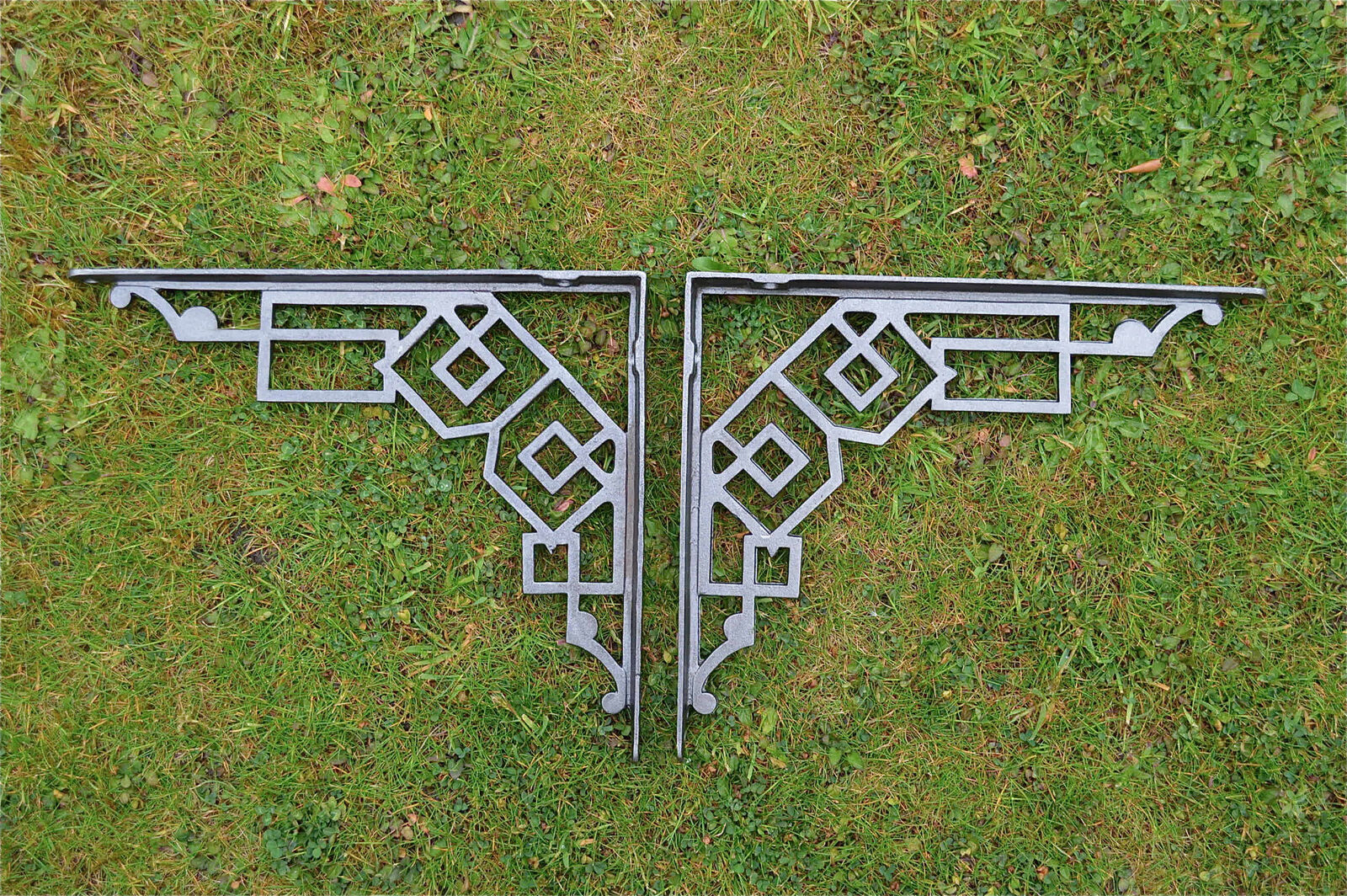 A pair of large cast iron Art Deco shelf brackets geometric design bracket