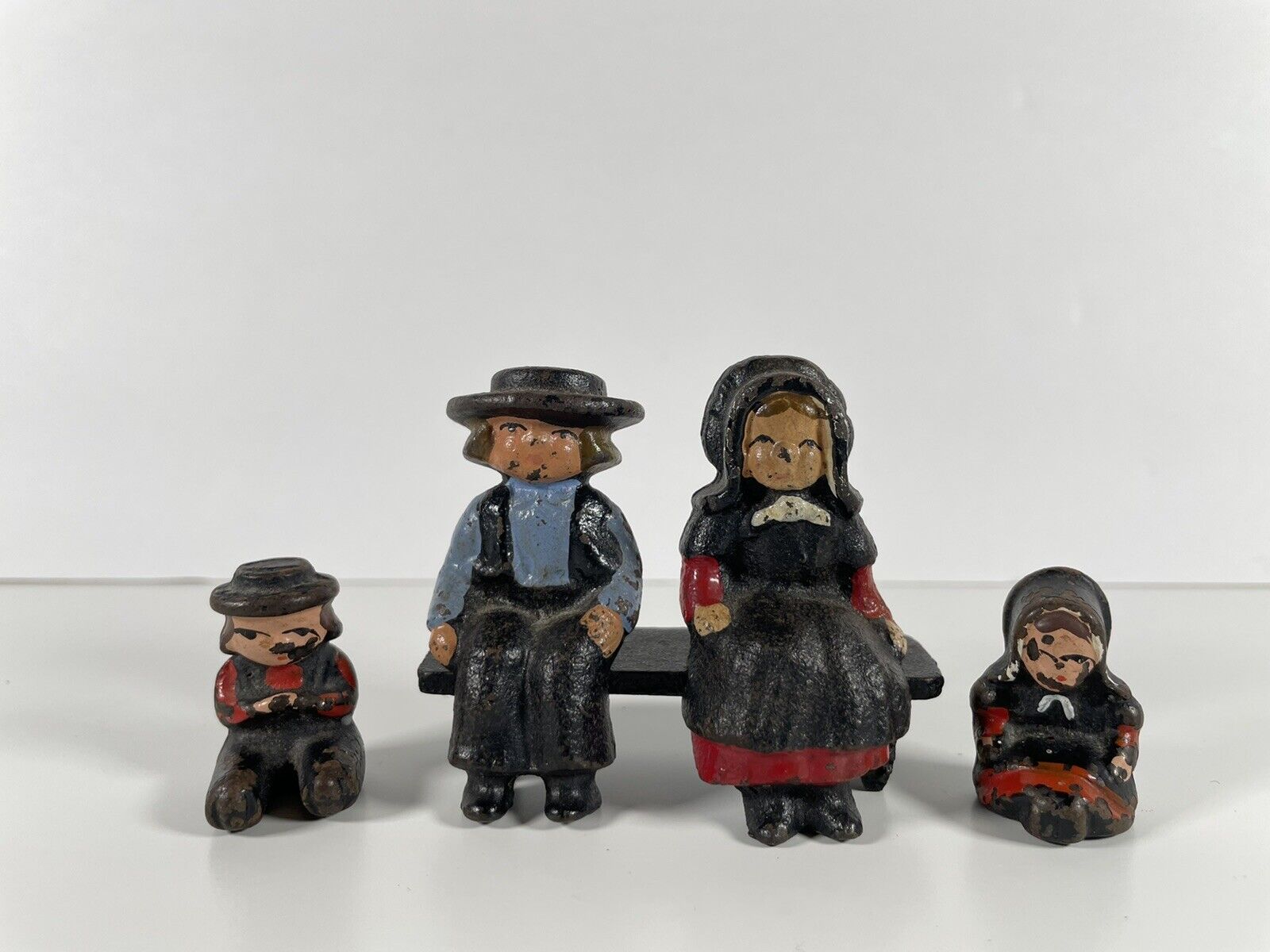 Vintage Cast Iron Amish Family Figurines Sitting On Bench Hand Painted
