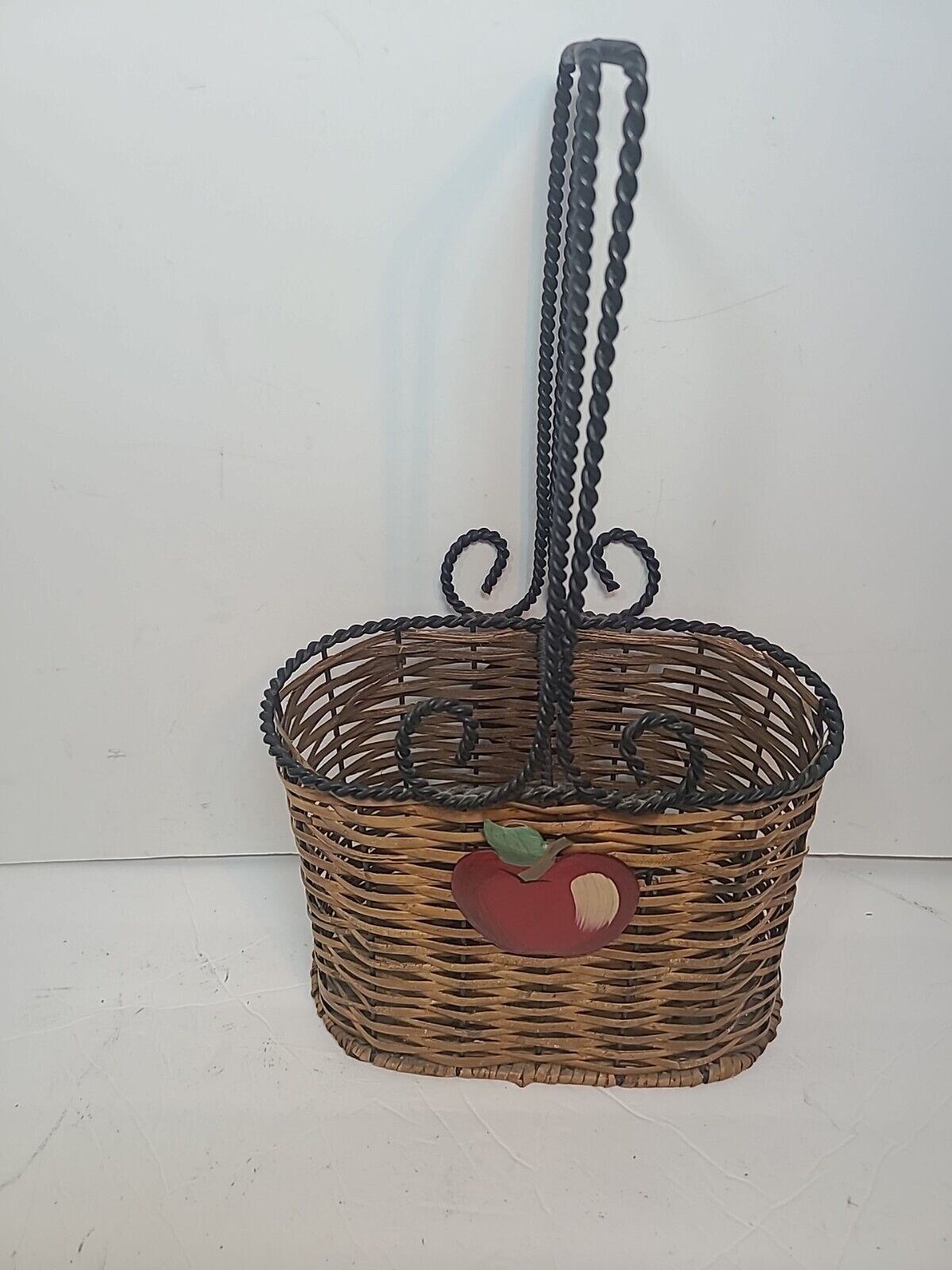 Oval Wicker Basket Featuring an Apple on Front & Back with Black Wire Handles