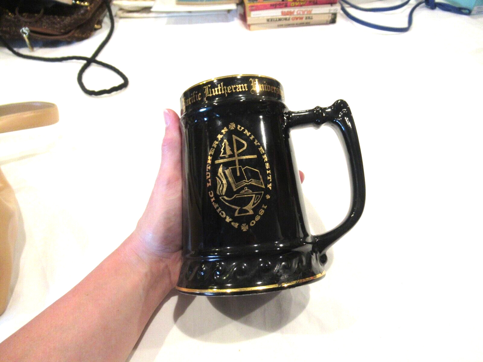 Pacific Lutheran University black mug with gold trim