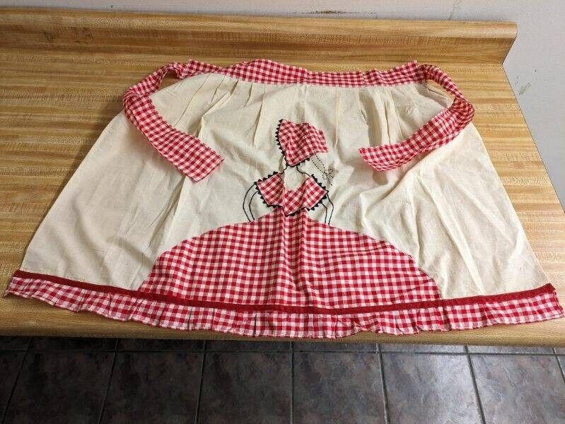 Vtg. handmade apron: lady with bonnet checkerboard clothing design.