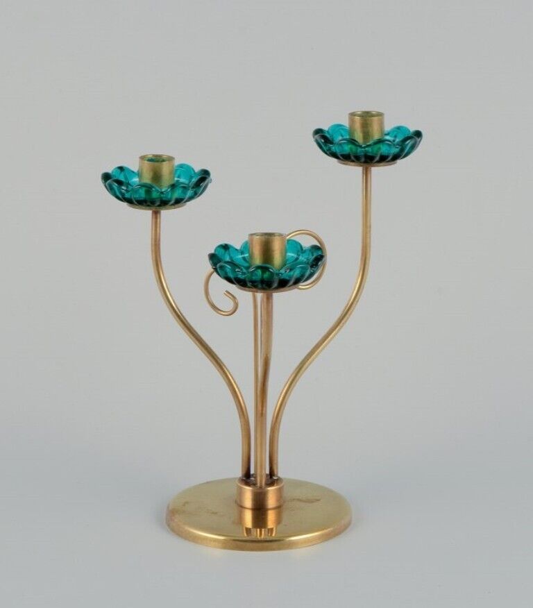 Gunnar Ander for Ystad Metall. Brass candlestick holder. Turquoise glass sleeves
