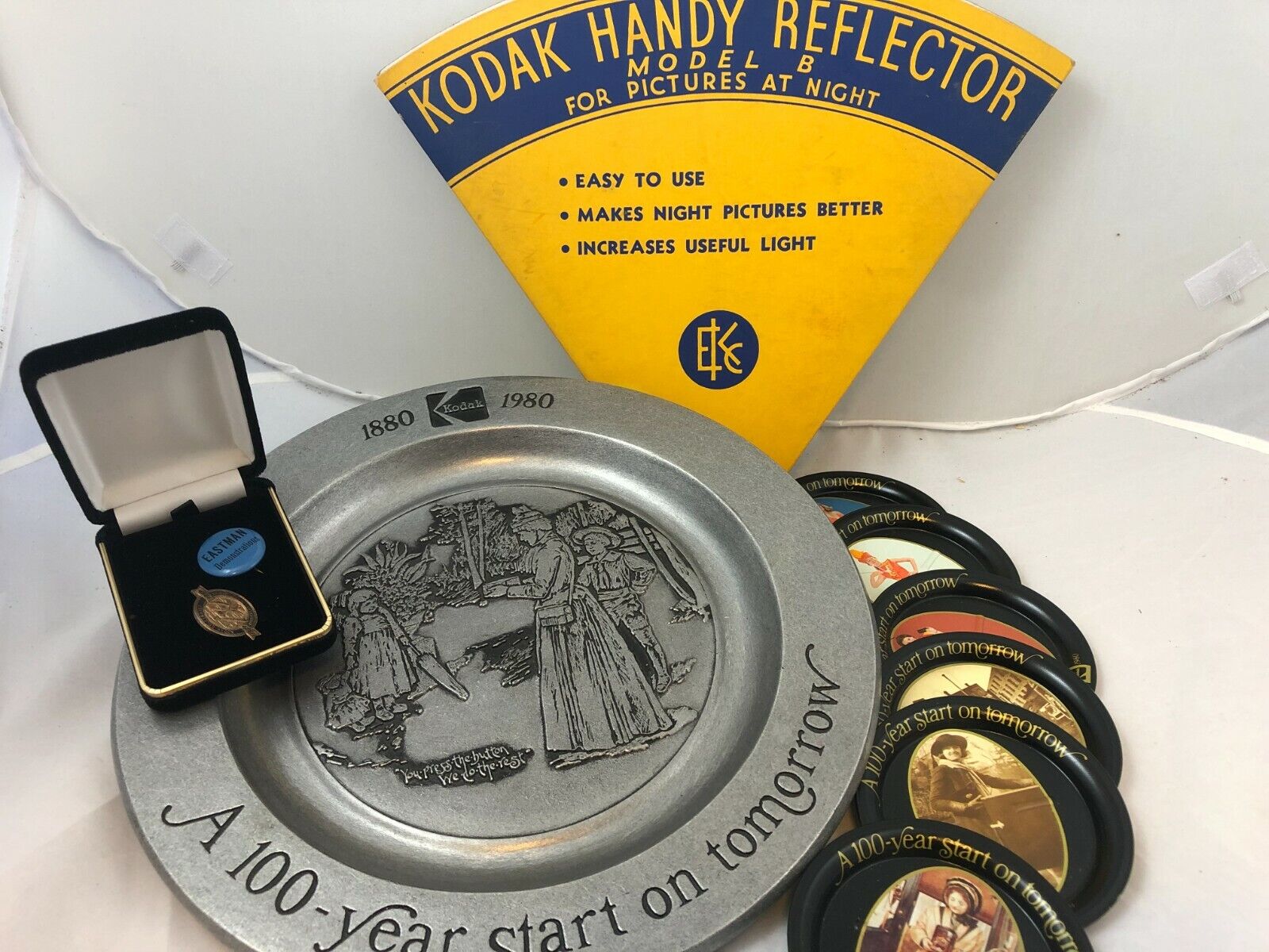 Lot of Vintage Kodak collectibles: 100-yr. anniv. plate, coasters + pins, etc.