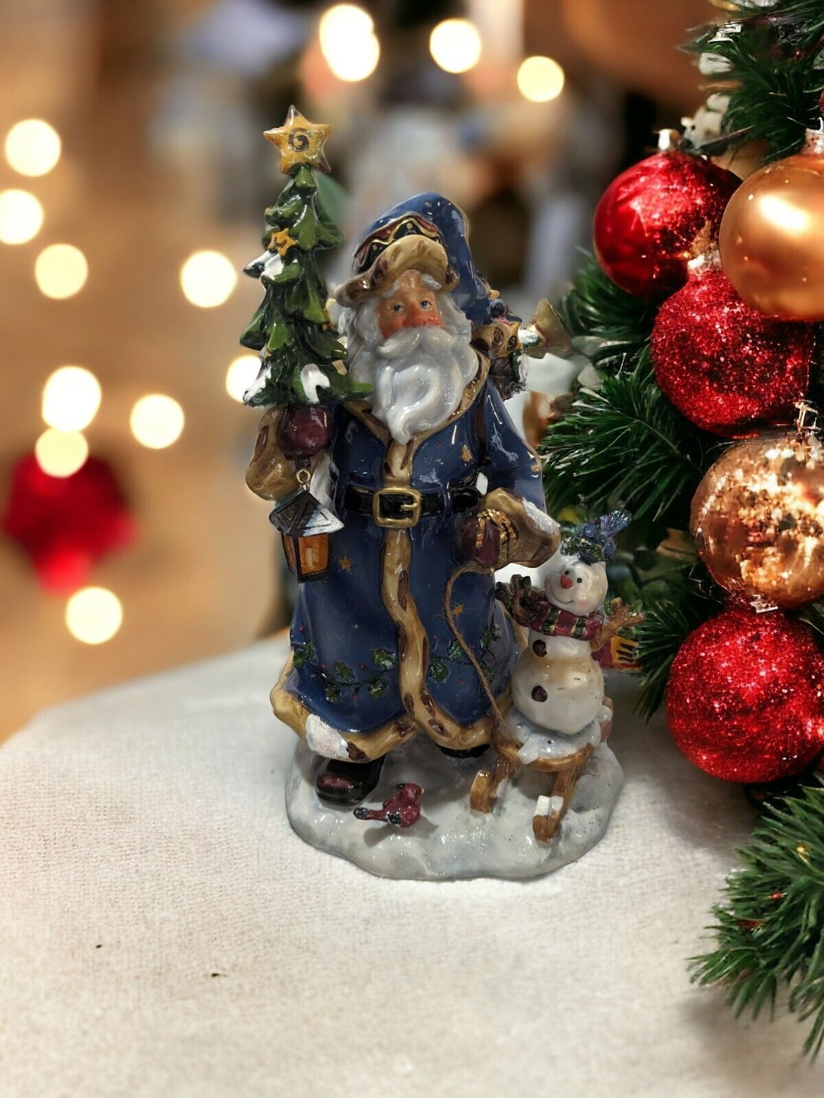 Old Fashioned Santa Figurine With Blue Coat And Hat, Bag Of Toys, And A Snowman 
