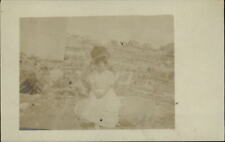 RPPC Young woman sitting on large rock huge hat ~ real photo postcard picture