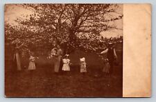 RPPC Adults Help Girls in Dresses Pick Flowers from Tree VINTAGE Postcard 1331 picture