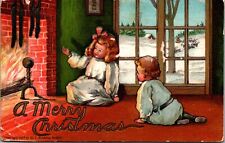 1907 EMBOSSED ROBBINS POSTCARD-A MERRY CHRISTMAS-CHILDREN WITH FIREPLACE J37 picture