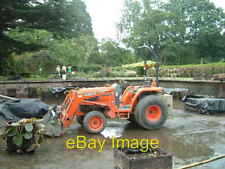 Photo 6x4 Tractor in a pond Tal-y-cafn A Kubota La402st compact tractor w c2004 picture