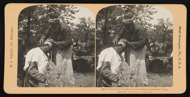 A Turkish barber shaving a customer\'s head, Constantinople, Turkey Old Photo
