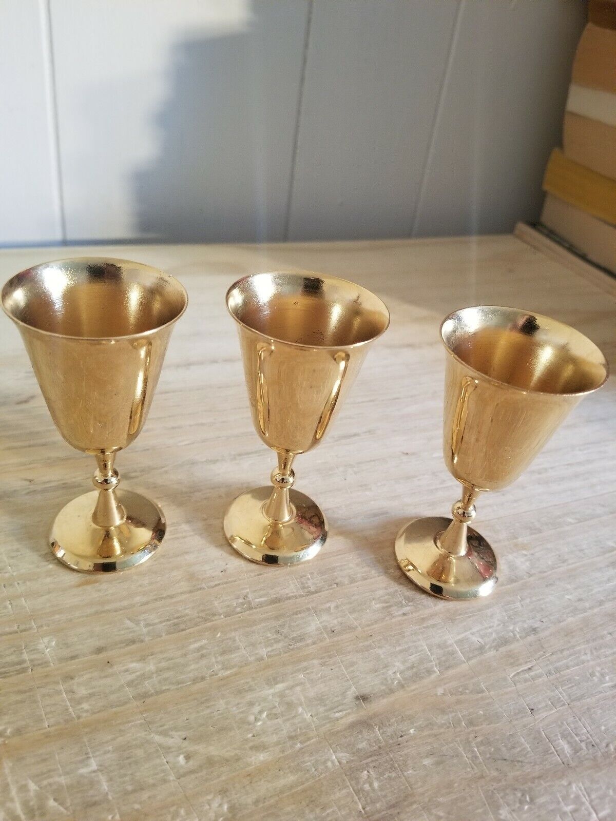 THREE BEAUTIFUL ALMOST 3 1/2 INCH TALL GOLD PLATED DRINKING COBLETS.NO MARKINGS.
