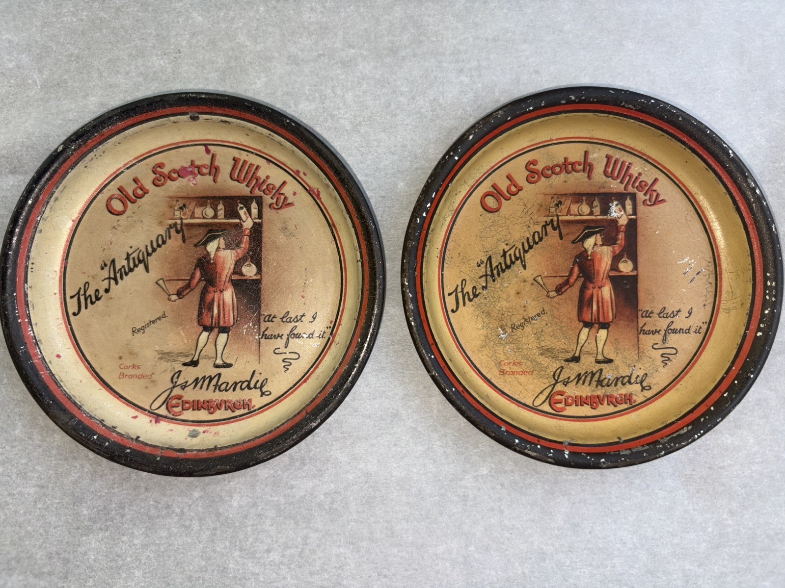 2-VERY RARE PRE PROHIBITION TIP TRAYS “ OLD SCOTCH WHISKY THE ANTIQUARY” app 4” 2-VERY RARE PRE PROHIBITION TIP TRAYS “ OLD SCOTCH WHISKY THE ANTIQUARY” app 4”