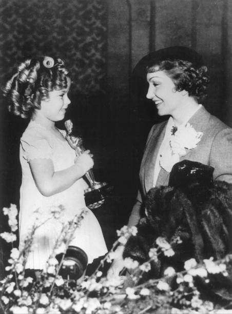The American Actress Claudette Colbert congratulating Shirley Temp- 1935 Photo The American Actress Claudette Colbert congratulating Shirley Temp- 1935 Photo