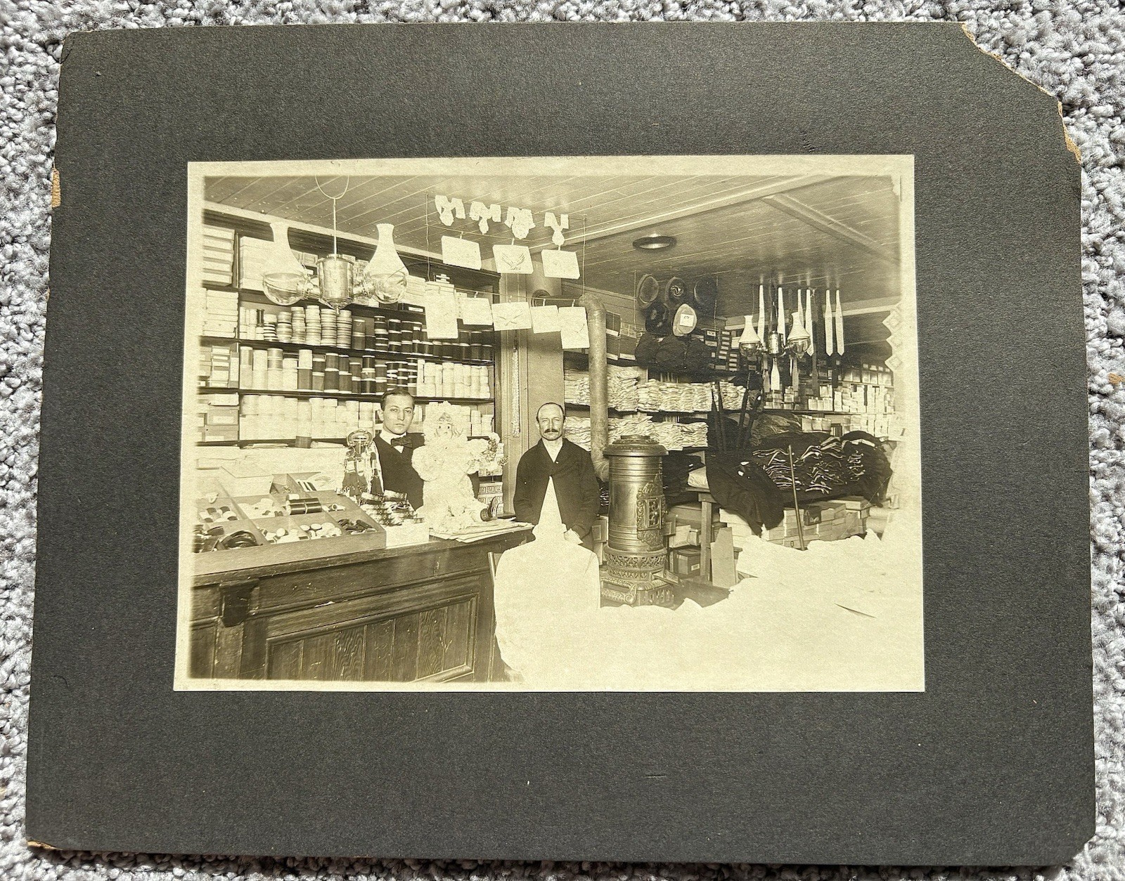Vintage antique mounted Photograph clothing store interior & creepy doll Vintage antique mounted Photograph clothing store interior & creepy doll