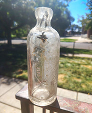 Vintage Clear Glass Bottle with Embossed Design, Unlabeled / No Brand Mark picture