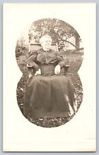 Postcard RPPC 1900s Woman Black Dress Portrait Widow? Sitting In Rocker Garden picture